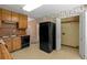 Practical kitchen featuring black appliances, light-colored cabinets, and durable flooring at 5340 Young Deer Dr, Cumming, GA 30041
