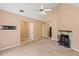 Spacious living room featuring neutral carpeting, fireplace, and view to a second room at 5340 Young Deer Dr, Cumming, GA 30041