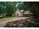 View of the home's exterior highlighting the attached carport and well-kept lawn at 5340 Young Deer Dr, Cumming, GA 30041