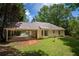 View of the home's exterior highlighting the attached carport and well-kept lawn at 5340 Young Deer Dr, Cumming, GA 30041
