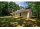 Side view of the exterior featuring a sunroom and well-maintained backyard at 5340 Young Deer Dr, Cumming, GA 30041