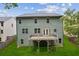 Aerial view of backyard featuring deck, privacy fence, and lush green lawn at 5655 Stevehaven Ln, Cumming, GA 30028