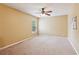 Spacious bedroom features neutral walls, plush carpeting, a ceiling fan and a window for natural light at 5655 Stevehaven Ln, Cumming, GA 30028