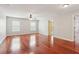 Large bedroom with wood floors, ceiling fan, and windows with bright, natural light at 5655 Stevehaven Ln, Cumming, GA 30028