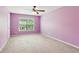 Bright bedroom is enhanced by natural light and the ceiling fan, making this room cozy and comfortable at 5655 Stevehaven Ln, Cumming, GA 30028