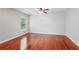 Bedroom with wood floors and a bright window overlooking a green yard at 5655 Stevehaven Ln, Cumming, GA 30028