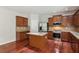 A modern kitchen features stainless steel appliances, a center island, and wooden cabinets at 5655 Stevehaven Ln, Cumming, GA 30028