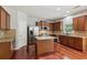 A modern kitchen features stainless steel appliances, a center island, and wooden cabinets at 5655 Stevehaven Ln, Cumming, GA 30028