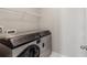 Laundry room with newer, stainless steel washer and dryer at 5655 Stevehaven Ln, Cumming, GA 30028