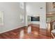 Bright living room leading to dining room, with high ceilings and hardwood floors at 5655 Stevehaven Ln, Cumming, GA 30028