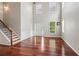 Bright living room with high ceilings, hardwood floors, and a staircase with wood treads at 5655 Stevehaven Ln, Cumming, GA 30028