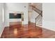 Bright living room with dining room, hardwood floors, and a staircase with wood treads at 5655 Stevehaven Ln, Cumming, GA 30028
