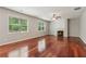 Inviting living room featuring hardwood floors, a fireplace, and large windows that provide ample natural light at 5655 Stevehaven Ln, Cumming, GA 30028
