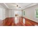 Spacious primary bedroom with tray ceiling, wood floors, and ensuite bathroom at 5655 Stevehaven Ln, Cumming, GA 30028
