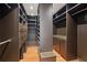 Spacious walk-in closet with built-in shelving and wood floors at 5655 Stevehaven Ln, Cumming, GA 30028