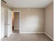 Empty room with carpeting, walls painted light tan, and a white door at 225 Fireside Way, Fairburn, GA 30213