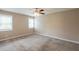 Spacious bedroom with neutral walls, plush carpeting, and a ceiling fan with light at 225 Fireside Way, Fairburn, GA 30213