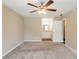 Bedroom view showcasing carpet, a ceiling fan, and an open doorway to the bathroom at 225 Fireside Way, Fairburn, GA 30213