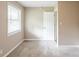 Bedroom features a window and white door at 225 Fireside Way, Fairburn, GA 30213