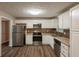 Updated kitchen featuring white cabinets, stainless steel appliances, and modern tile backsplash at 225 Fireside Way, Fairburn, GA 30213