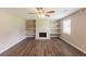 Inviting living room featuring a stone fireplace, built-in shelves, and hardwood floors at 225 Fireside Way, Fairburn, GA 30213