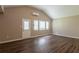 Spacious living room with wood-look floors, neutral walls, and natural light through window blinds at 225 Fireside Way, Fairburn, GA 30213