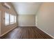 Bright living room featuring a high ceiling, wood-look floors, and natural light through the window blinds at 225 Fireside Way, Fairburn, GA 30213