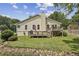 Back exterior of home with well-manicured backyard and wooden deck perfect for outdoor living at 255 Broken Lance Pl, Johns Creek, GA 30022