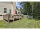 Expansive backyard featuring a well-maintained lawn, exterior of home, and inviting wooden deck at 255 Broken Lance Pl, Johns Creek, GA 30022
