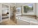 Bright bathroom with soaking tub and glass shower at 255 Broken Lance Pl, Johns Creek, GA 30022