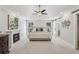 Spacious bedroom with fireplace, tray ceiling, ceiling fan, and en suite bathroom at 255 Broken Lance Pl, Johns Creek, GA 30022