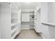 Walk-in closet with custom shelving and plenty of storage space at 255 Broken Lance Pl, Johns Creek, GA 30022