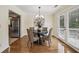 Cozy dining area with hardwood floors, stylish chandelier, and access to the outdoor deck at 255 Broken Lance Pl, Johns Creek, GA 30022