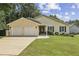 Charming single-story home with a well-manicured lawn, attached two-car garage, and inviting front entrance at 255 Broken Lance Pl, Johns Creek, GA 30022