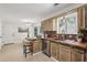 Bright kitchen offers tile floors, wooden cabinetry, stainless steel appliances, and lots of light at 255 Broken Lance Pl, Johns Creek, GA 30022