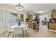 Eat-in kitchen showcasing a sunny breakfast nook with bay window, tile floors, and wood cabinetry at 255 Broken Lance Pl, Johns Creek, GA 30022