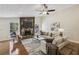 Bright living room featuring a stone fireplace, ceiling fan, and elegant decor, creating a cozy atmosphere at 255 Broken Lance Pl, Johns Creek, GA 30022