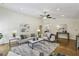 Bright living room boasts high ceilings, chic decor, hardwood floors, and lots of natural light at 255 Broken Lance Pl, Johns Creek, GA 30022