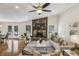 Spacious living room with stone fireplace, hardwood floors, and a cozy seating area with lots of natural light at 255 Broken Lance Pl, Johns Creek, GA 30022
