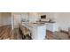 Modern kitchen featuring an island with seating, granite countertops, and stainless steel appliances at 55 Bandimere Pkwy, Dallas, GA 30157