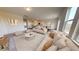 Bright living room featuring neutral decor, plush seating, and an open concept design to kitchen and dining areas at 55 Bandimere Pkwy, Dallas, GA 30157