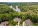 Scenic aerial view showcases a luxurious estate nestled amidst lush greenery and river views at 8470 Lazy Oaks Ct, Atlanta, GA 30350