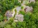 Aerial view of a luxurious home surrounded by lush trees at 8470 Lazy Oaks Ct, Atlanta, GA 30350