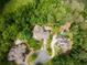 Aerial view showcasing multiple luxury homes, mature landscaping, and river access at 8470 Lazy Oaks Ct, Atlanta, GA 30350