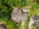 Aerial view showcases the home's expansive layout, outdoor patios, and lush surrounding greenery at 8470 Lazy Oaks Ct, Atlanta, GA 30350