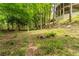 Lush wooded backyard on a sloped lot, ideal for privacy, relaxation and a connection with nature at 8470 Lazy Oaks Ct, Atlanta, GA 30350