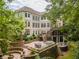 Stunning backyard featuring a large patio, stone retaining walls, and lush greenery at 8470 Lazy Oaks Ct, Atlanta, GA 30350