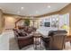 Cozy basement living area featuring a large seating area, a piano, and custom built in shelving at 8470 Lazy Oaks Ct, Atlanta, GA 30350