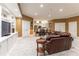 Finished basement with large seating area, tile floors, and a kitchenette in the background at 8470 Lazy Oaks Ct, Atlanta, GA 30350