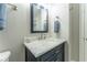 Bathroom featuring a navy vanity with marble countertop and brushed nickel fixtures at 8470 Lazy Oaks Ct, Atlanta, GA 30350